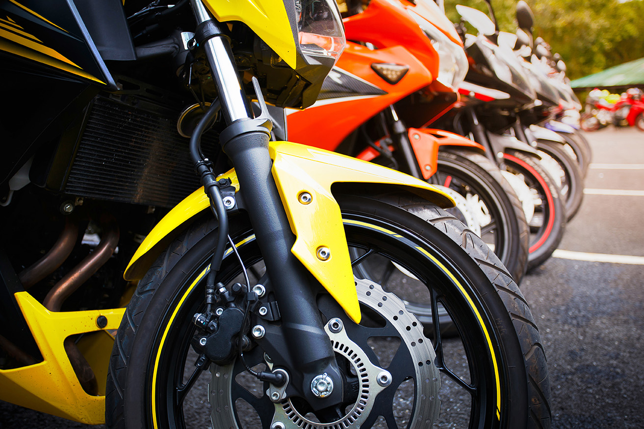 motorcycles standing in the row on asphalt road closeup